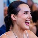 A woman laughing at an outdoor summer gathering