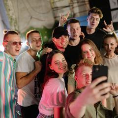 A slightly blurry group selfie taken by friends in the middle of a party